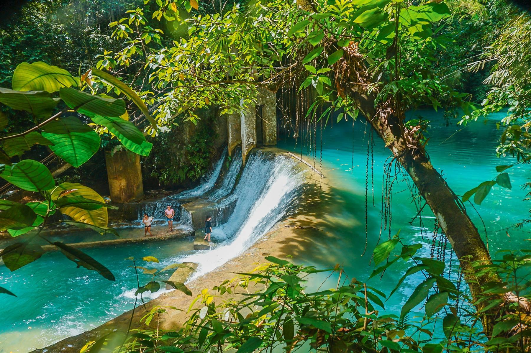 Turquoise cascading pools of Kawasan Falls surrounded by lush tropical jungle in Badian, Cebu